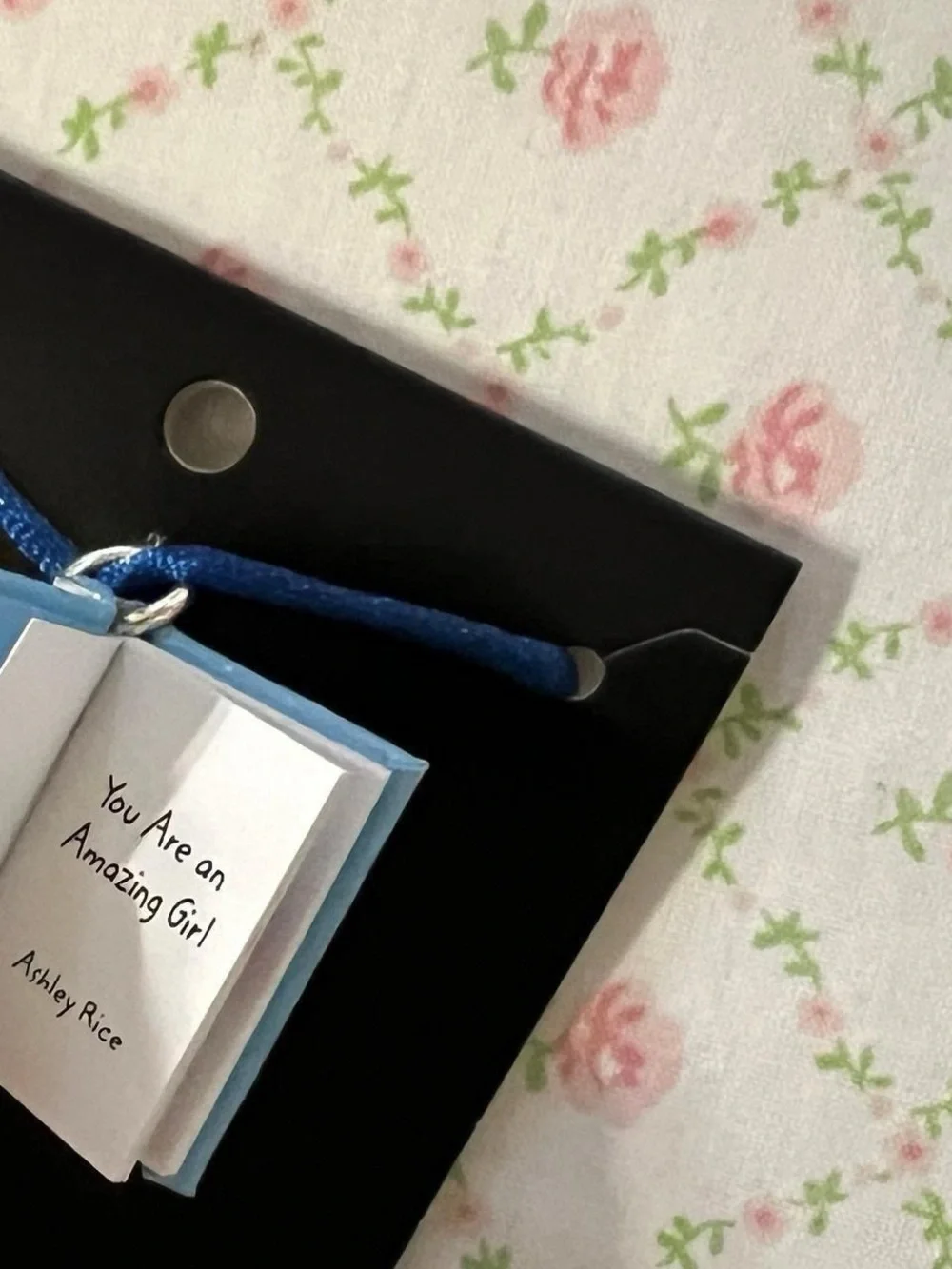 Miniature poetry book necklace.  “You are an amazing girl”.